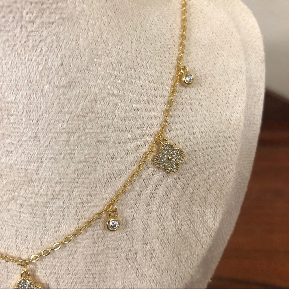 gold dangle station necklace encrusted clover charm round bezel set Cubic Zircon